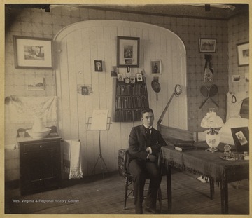 McDaniel is pictured sitting at a table. The photo is from a photograph album of late nineteenth century images featuring residents from Keyser, W. Va.
