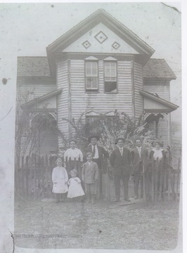 A family of unidentified persons poses in front of the home of Jack Warhop, pitcher for the New York Yankees. 