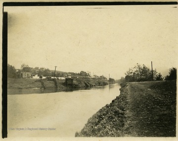 This image is part of the Thompson Family of Canaan Valley Collection. The Thompson family played a large role in the timber industry of Tucker County during the 1800s, and later prospered in the region as farmers, business owners, and prominent members of the Canaan Valley community.The image shows a view of the Cumberland Canal in Cumberland, Md.