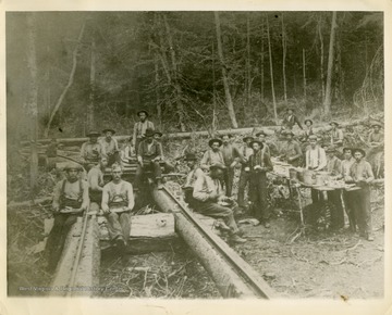 This image is part of the Thompson Family of Canaan Valley Collection. The Thompson family played a large role in the timber industry of Tucker County during the 1800s, and later prospered in the region as farmers, business owners, and prominent members of the Canaan Valley community.The crew takes a meal break from building the Stringer Rail Road.