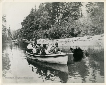 This image is part of the Thompson Family of Canaan Valley Collection. The Thompson family played a large role in the timber industry of Tucker County during the 1800s, and later prospered in the region as farmers, business owners, and prominent members of the Canaan Valley community.Unidentified people boating on Blackwater River during a Sunday afternoon.