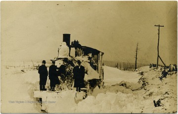 This image is part of the Thompson Family of Canaan Valley Collection. The Thompson family played a large role in the timber industry of Tucker County during the 1800s, and later prospered in the region as farmers, business owners, and prominent members of the Canaan Valley community.Unidentified men stand next to a snow and ice covered train on the Davis Branch of the W.M.R.R.