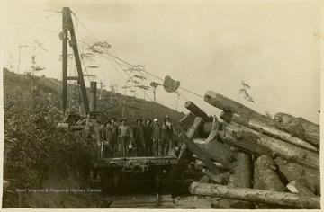 The overhead, or cableway skidder, used several different cables raised at both ends, from the skidder to trees above the loading area, and allowed loggers to raise log loads above ground obstructions in order to move them. The skidder in this image is shown moving several logs.This image is part of the Thompson Family of Canaan Valley Collection. The Thompson family played a large role in the timber industry of Tucker County during the 1800s, and later prospered in the region as farmers, business owners, and prominent members of the Canaan Valley community.