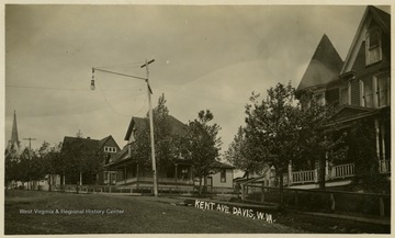 The residence is pictured in the center beside the lamp post.This image is part of the Thompson Family of Canaan Valley Collection. The Thompson family played a large role in the timber industry of Tucker County during the 1800s, and later prospered in the region as farmers, business owners, and prominent members of the Canaan Valley community.