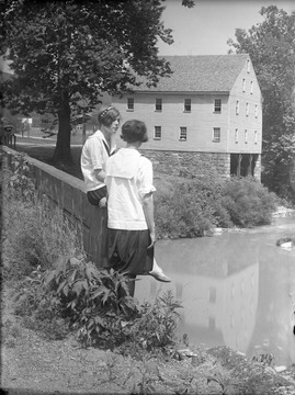 Two unidentified girls loiter outside of the historic building. 