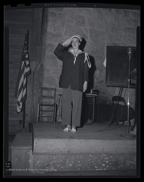 An unidentified girl dressed as a sailor poses on the stage at the leadership event. 