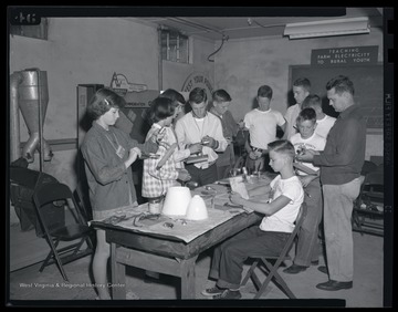A group of campers make lamps during their class activity. 