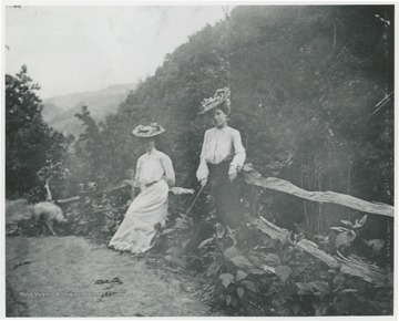 Mrs. Ro. Murrell and friend pictured at scenic overlook near Hinton in Summers County, W. Va.