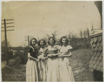 Four unidentified girls pose together for a group photo. 