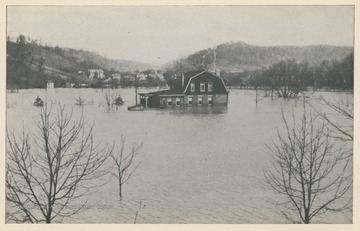 Photo postcard of an unidentified house surrounded by floodwater in Wheeling, W. Va. Postcard is part of a souvenir book of 1913 flood images.