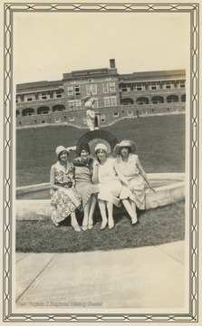 Four women sit on a fountain outside the Conely Hospital building at the Hopemont Sanitarium in August, 1930.