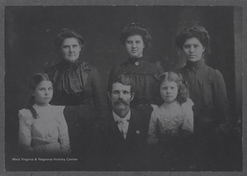 Group portrait of James W. Cooan (Koon) and his family.  Other family members in the portrait are likely his wife and four daughters or other female relatives.