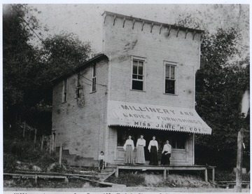 From left to right are an unknown boy, Janie McCoy (Mick), Mary Sue Campbell (Fletcher), Eugenia Campbell (Fidler), and Minnie Campbell (Shreve). The Weston-Central Telephone Company, which was owned by Hugh Amos, was located in the upstairs section of the building. The operators were known as 'Hello Girls.'