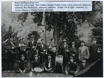 In the back row, from left to right, are Wed Fiddler, George Fiddler, Frank Amos, unknown, unknown, unknown, Roy Brosius Sr., unknown, and unknown.Seated, from left to right, are unknown, Cy Taylor, unknown, Charlie Fiddler, and unknown. 