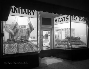 Street view of Sanitary Meats, a butcher shop selling a variety of meats. 