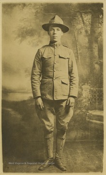 Portrait of an unidentified male in a military uniform in what appears to be a photo studio.