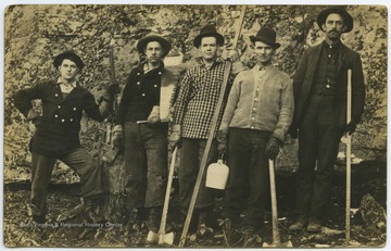 Walter Dix Lewis, left, and Will Lewis, second from left, pose holding axes with three unidentified associates. The men are likely preparing to log. 