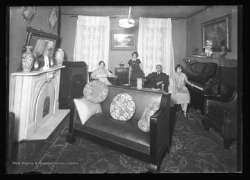 Four family members pose in their sitting room in Franklin W. Va.