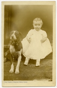 Mary E. Nuzum at 11 months, with dog.