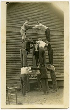 Unidentified members of the Harper family making a pyramid.