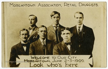 Six druggists pose for a formal group photo. 