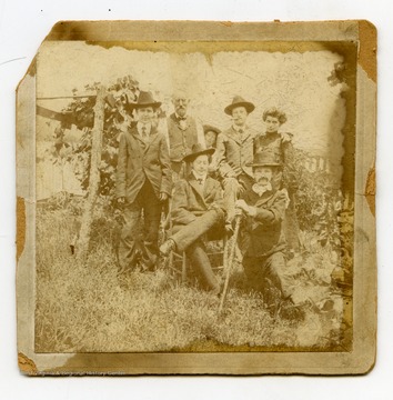 Three young "men" in the front are likely cross-dressing women.