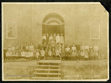 The students and staff of the Sabraton School gather in front of the school building for a group portrait.