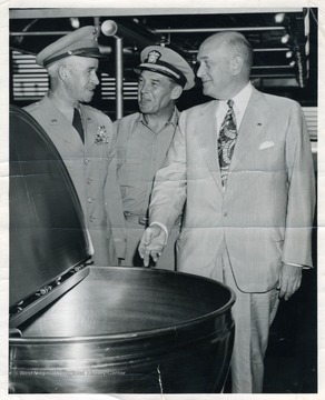 General Omar N. Bradley, Admiral Edward C. Ewen, and Secretary of War Louis A. Johnson discuss the military crisis in Korea around a steam kettle in Guam.