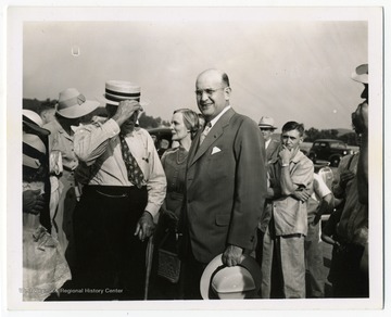Assistant Secretary of War Louis Johnson (center, bareheaded) attends the opening of an airline at the Harrison County Airport, now known as the Benedum Airport.
