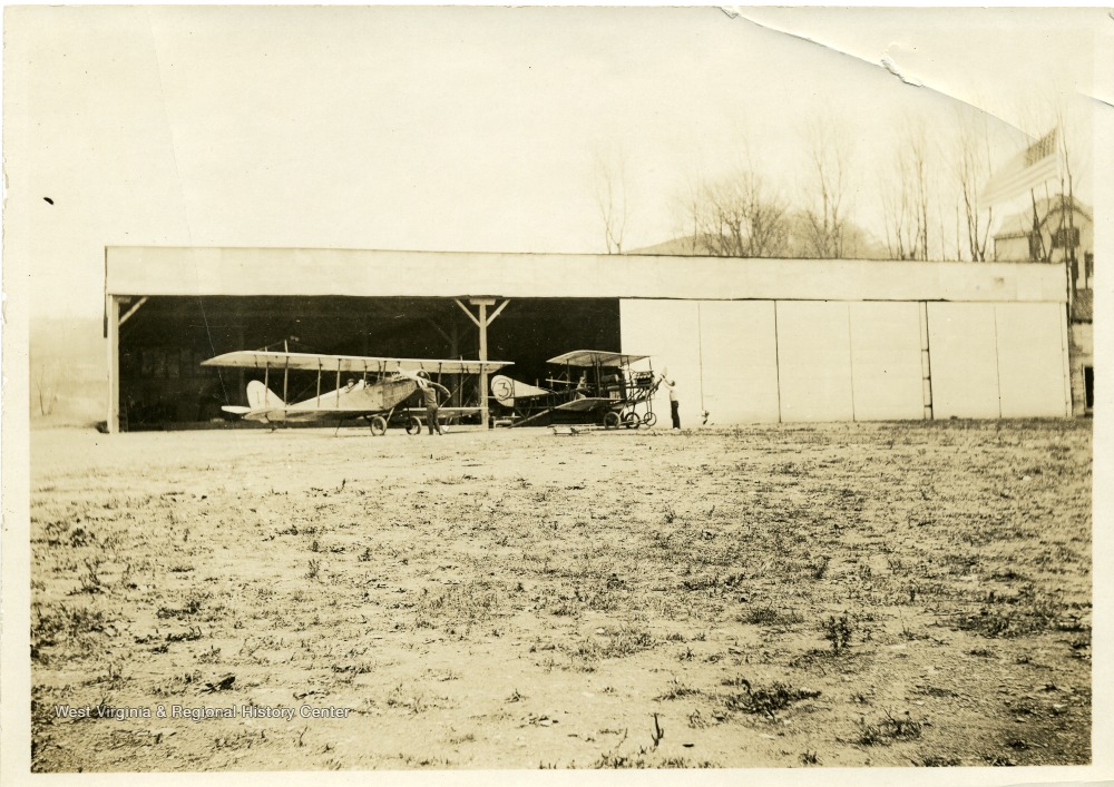 Preparing to start aircraft #1 Curtiss JN-4 and "grass cutter" training plane. Plane #1 was destroyed in a crash on August 4, 1917.  In this crash Cadet C.B. Lambert (of Welch, West Virginia) was killed, and Lieutenant William Frey was injured.  (See newspaper Wheeling Register, August 4, 1917.)  Each ground crewman in the picture is about to "turn over the prop" in order to start the engines of the airplanes.
