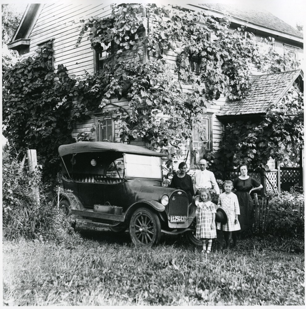 Olga Aegerter Holtkamp and family (Benjamin Holtkamp, Nellie Schroth Aegerter) standing beside a car.  Helvetia, W. Va.