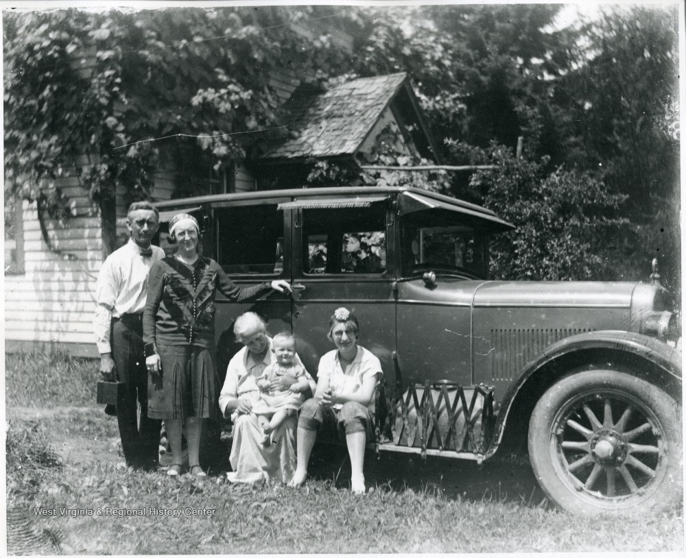 Holtkamp and Aegerter Family members in front of a car, Helvetia, W. Va.