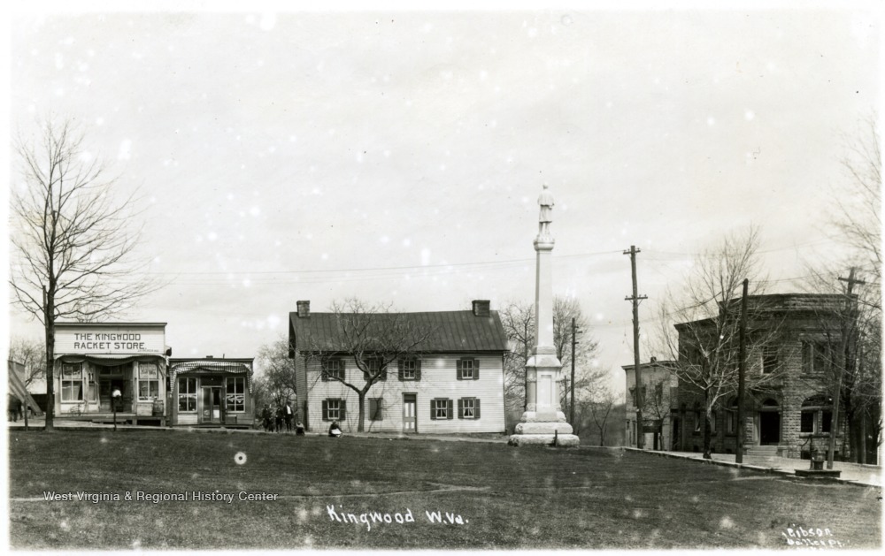 'Front view of Price's Tavern (white building immediate left of monument) where Preston county was formed.  Upstairs bedroom, April 1818.  Built before 1810, it was an inn until 1882.  Id by Norman Chipps, July 2nd, 1993.'