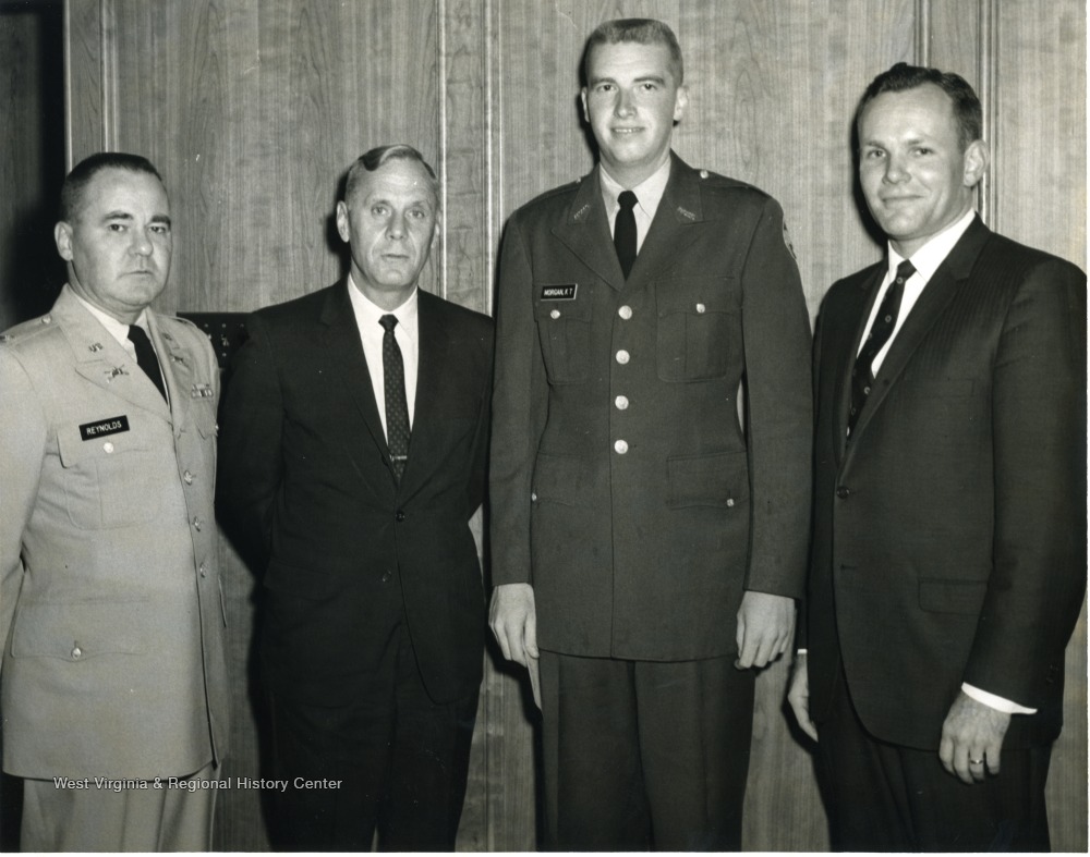 Left to right, Col. Reynolds, ROTC; WVU President, Paul A. Miller; K.T. Morgan, military graduate; Unknown. 