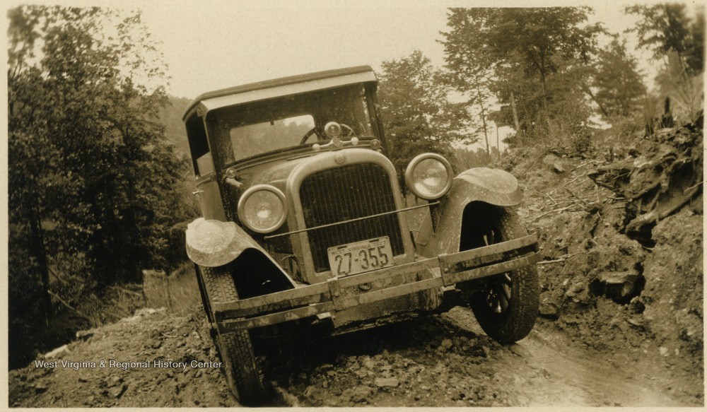 A vehicle on an unpaved road. The vehicle has a West Virginia license plate and is thought to belong to the Mathers/Barrick family.