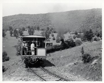 Locomotive and passenger cars; Walter Good, conductor, on left side with hand on walkway chain; P.F. "Bus" Long, C&amp;O station agent, to Walter's right, also with hand on chain; photograph from Richard Carter, N. White Hall Rd., Norristown P.O. 3 P.A.