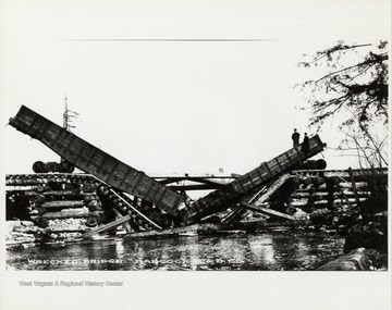 Collapsed bridge and wreck of train box cars.