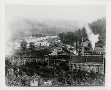 Lumber mill with town in the background.  