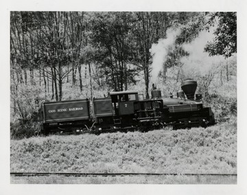 Side view of Shay No. 7 train engine. Tracks in foreground.