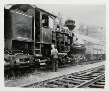 Philip Bagdon looking at Shay #4 train engine. 