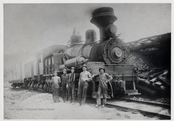 Shay train engine No. 8 with five men standing beside it.