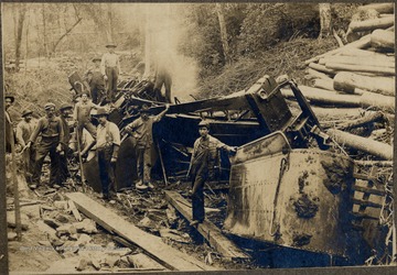Men stand amongst wreckage.