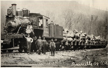 Train engine pulling lumber carts with crew.  Sewell Valley, Rainelle, W.Va. in Greenbrier County.