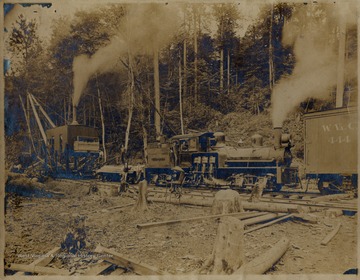 Train engine and other machinery in logging area.  