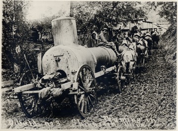Team of horses pulling a large piece of equipment.
