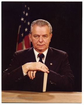 Portrait of Senator Robert C. Byrd with his hands perched on a book.