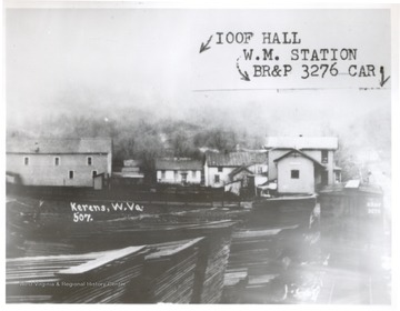 View of Kerens, W. VA. including the I.O.O.F. Hall, W.M. Station, and BR&P 3276 car.  Lumber piles visible in the foreground.