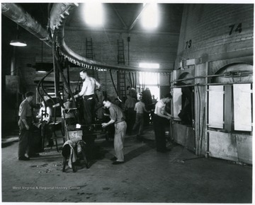 Glass workers inside of the Fostoria Glass Comany.
