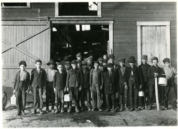 A group portrait of boys going home from Monongah Glass Works, Fairmont, W. Va.  Credit National Archives 102-LH-185.<br />