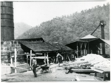 This picture was taken in April or May 1931 while stoker was being installed. This is the only picture showing the foundation of old smoke stack and the old board roof over pans.